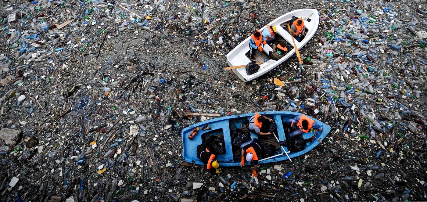 Boats in dam of plastic pollution
